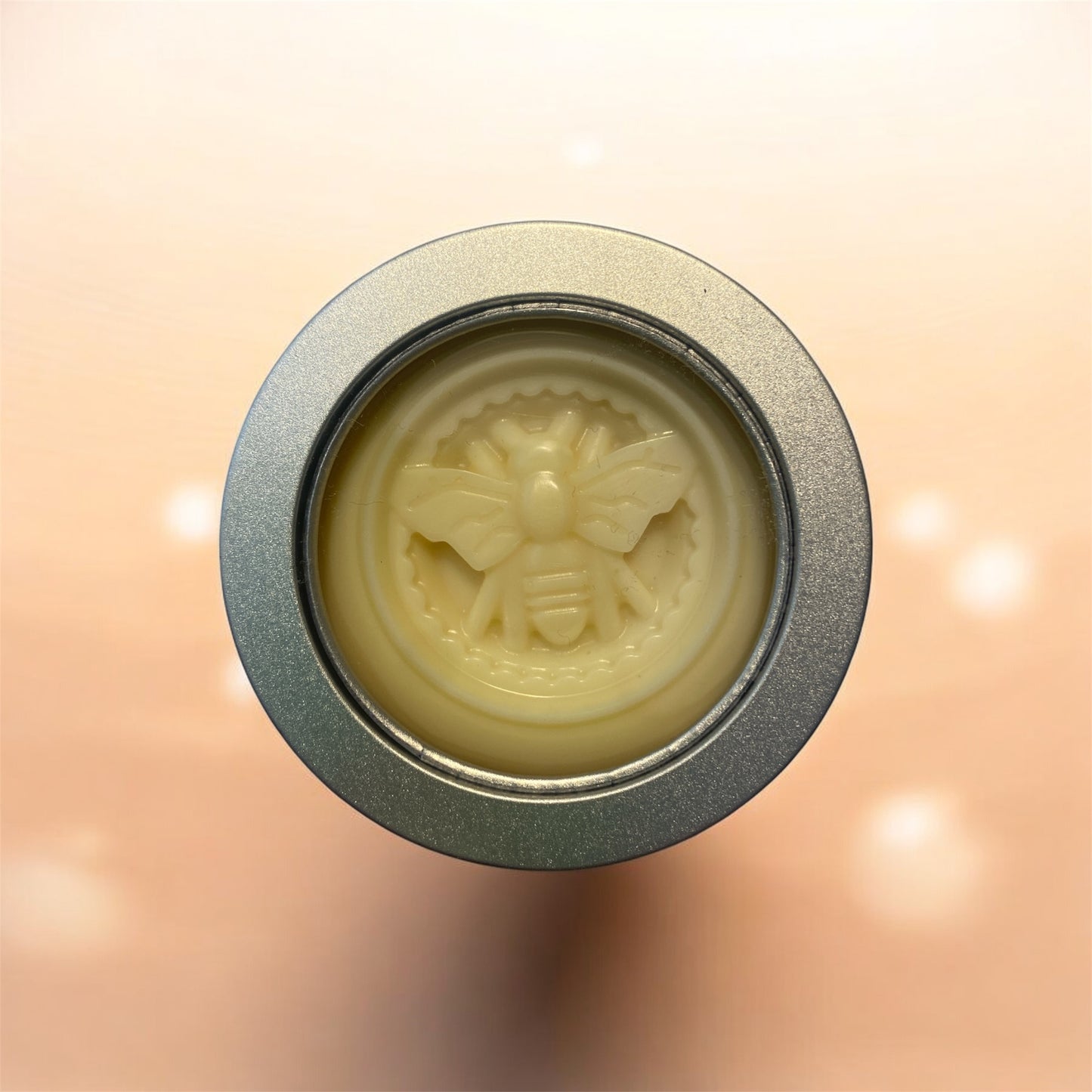 solid lotion bar on peach background with white sparkles