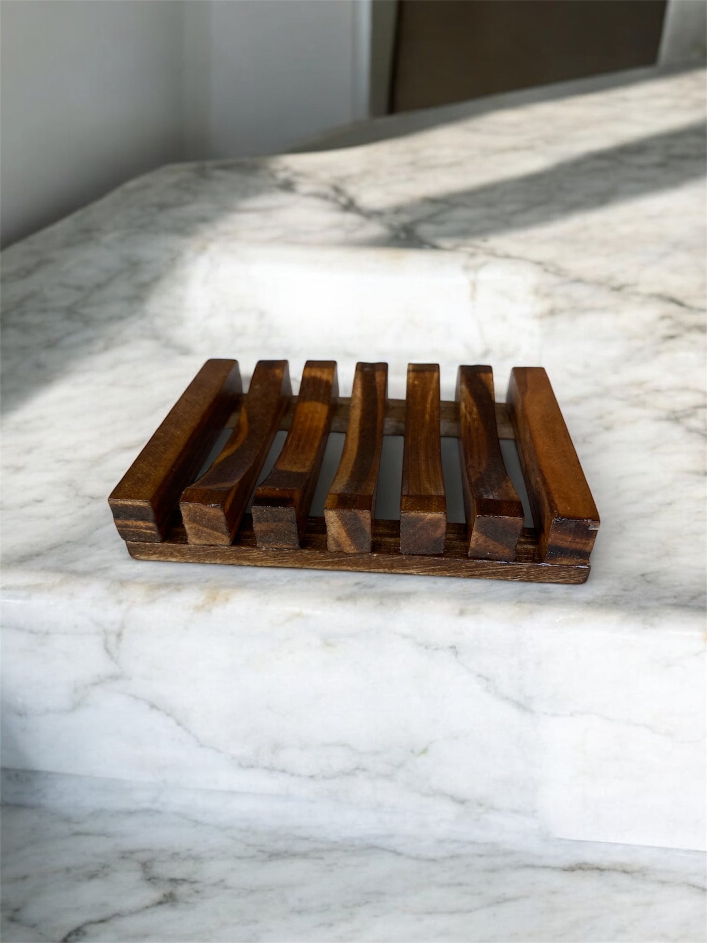 wood soap dish on marble counter